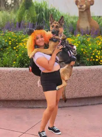 Liz C, a pet trainer at Bauser's Pet Training, holding a German shepherd
